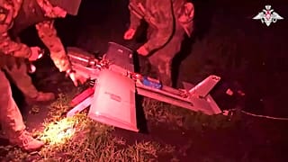 Des soldats russes préparent un drone d'attaque pour voler vers les positions ukrainiennes dans un lieu non divulgué, 18 juillet 2025.
