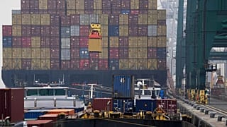 A container is loaded onto a ship in the Port of Antwerp, 17 August, 2022