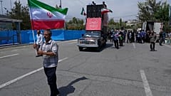 Ein Gläubiger hält eine iranische Flagge zu Beginn einer anti-amerikanischen und anti-israelischen Demonstration nach dem Freitagsgebet in Teheran, Iran, Freitag, 25. Juli 2025.