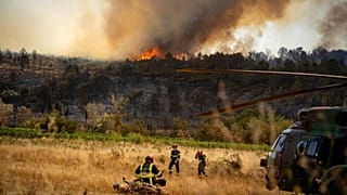 This photo provided by the Securite Civile on Friday, 8 August 2025 shows firefighters next to a wildfire Thursday, 7 August 2025 in southern France.