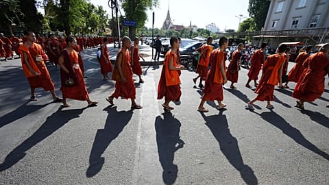 Cambodian Buddhist monks march on a street as they organise a ceremony to honour soldiers killed in recent border clashes with Thai forces, in Cambodia, Friday, Aug. 8, 2025.