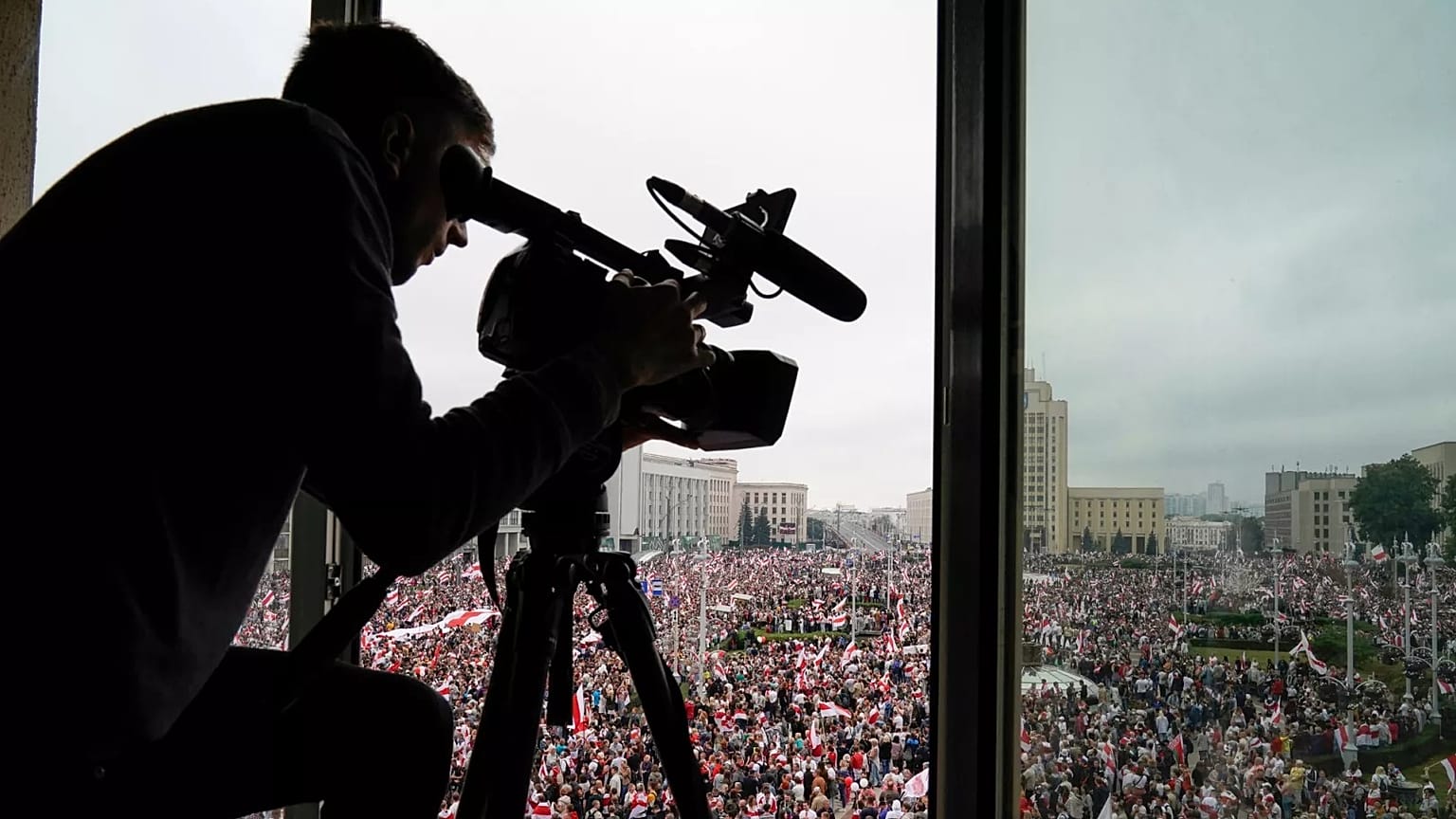 A cameraman works as Belarusian opposition supporters rally in Independence Square in Minsk, 23 August, 2020