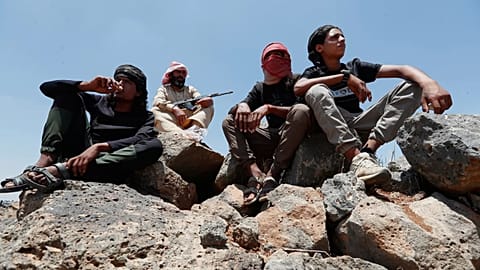 Bedouin fighters gather as Syrian government security forces block them from entering Suwayda province, 20 July, 2025