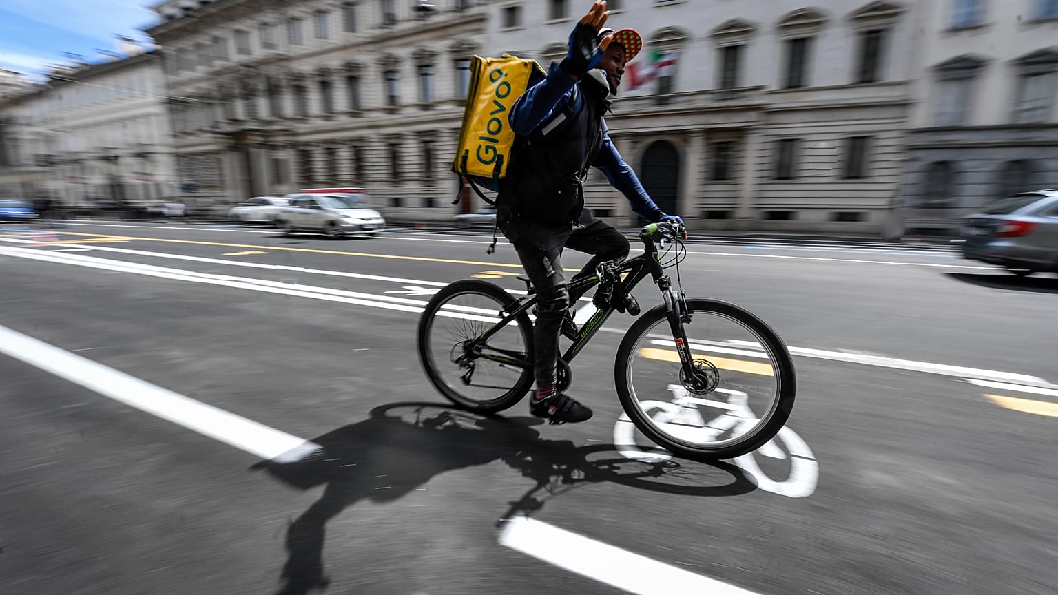 Delivery workers became indispensable during the COVID-19 pandemic, like this Glovo courier pictured in Milan, Italy in 2020.