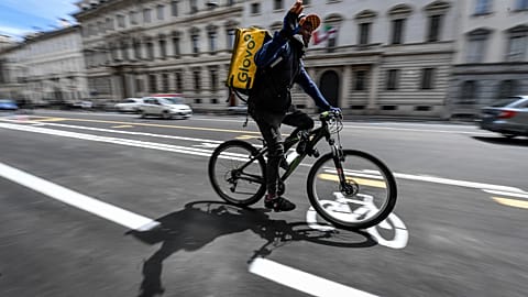 Delivery workers became indispensable during the COVID-19 pandemic, like this Glovo courier pictured in Milan, Italy in 2020.