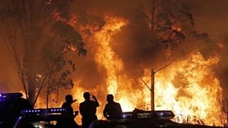 Las llamas de un incendio, con la Guardia Civil en primer plano