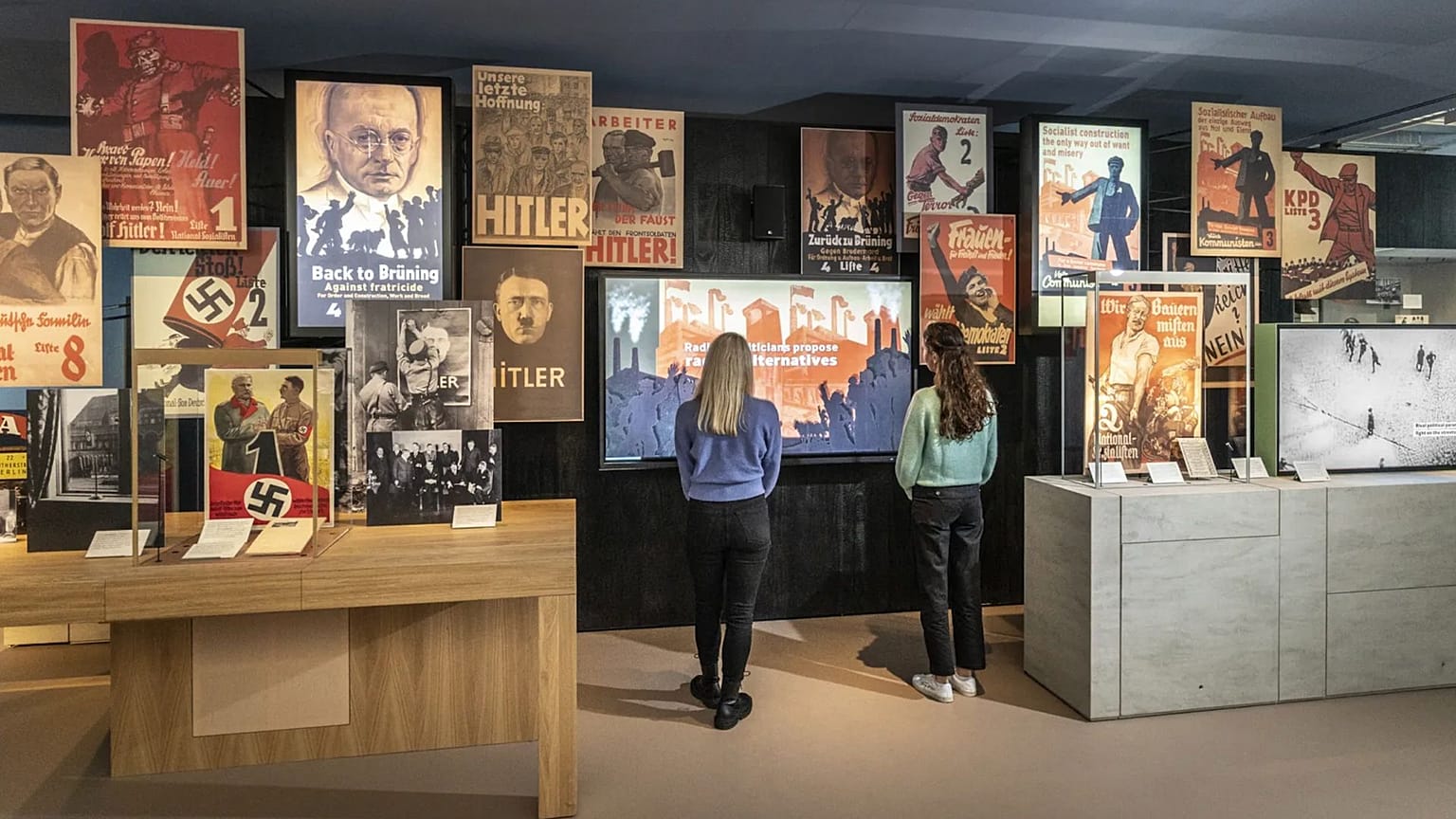 Two visitors look at an exhibit inside the Imperial War Museum. 