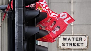 A flag hangs on the traffic lights at Water Street, Liverpool, where a car drove into crowds of football fans on 26 May, 2025.