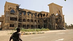 صورة أرشيفية - جندي يسير أمام القصر الجمهوري في الخرطوم، السودان، بعد سيطرة الجيش السوداني عليه، 21 مارس 2025. (صورة من وكالة أسوشيتد برس، أرشيفية)