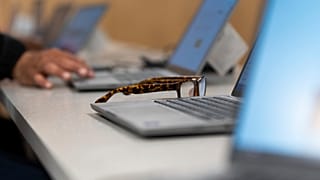 FILE: Reading glasses rest by a laptop during a keyboard basics class in Portland, OR, 15 May 2025, illustration