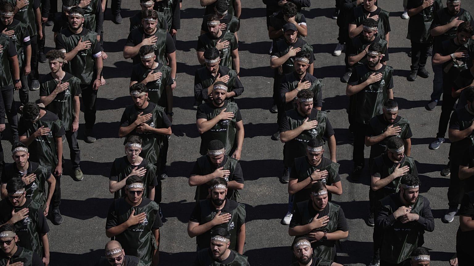 FILE: Hezbollah supporters beat their chests as they march in Beirut, 6 July 2025