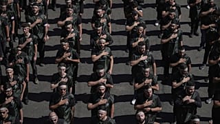 FILE: Hezbollah supporters beat their chests as they march in Beirut, 6 July 2025