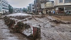 Local residents look at flash flooding due to heavy rains in a neighbourhood of Mingora, 15 August, 2025