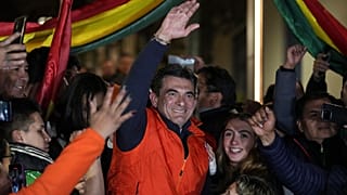 Presidential candidate Rodrigo Paz, center, addresses supporters after early results showed him leading in the presidential election in La Paz, Bolivia, Sunday, Aug. 17, 2025.