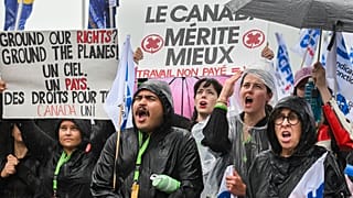 Air Canada employees and union members protest outside the Air Canada headquarters in Montreal, Sunday, Aug. 17, 2025.