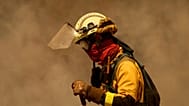 A firefighter works against the Rebordondo fire, in Ourense, on Monday, August 18, 2025.