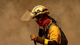 A firefighter works against the Rebordondo fire, in Ourense, on Monday, August 18, 2025.