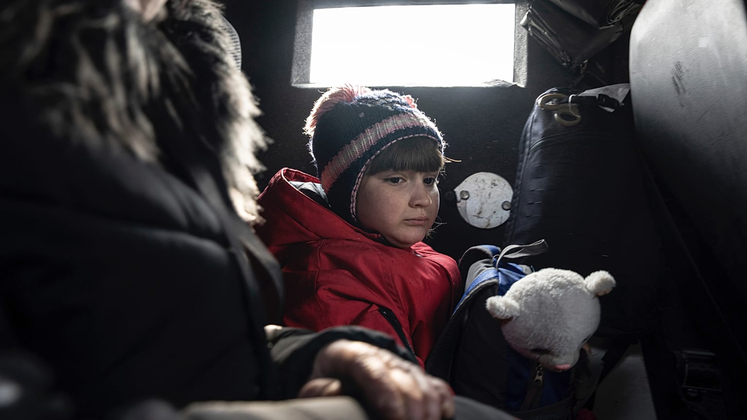 Una niña viaja con su madre en una furgoneta durante la evacuación por parte de la Policía ucraniana en Avdiivka, Ucrania, el 7 de marzo de 2023. 