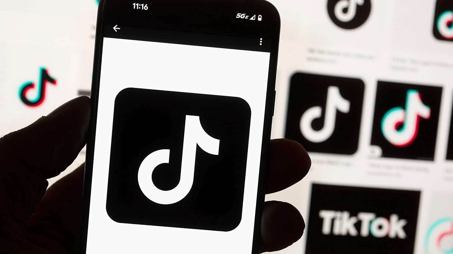 FILE - The TikTok logo is displayed n a mobile phone in front of a computer screen displaying the TikTok home screen, Oct. 14, 2022, in Boston.
