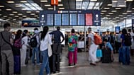 Επιβάτες κοιτάζουν τον πίνακα πληροφοριών αναχωρήσεων στο αεροδρόμιο Orly, κοντά στο Παρίσι.