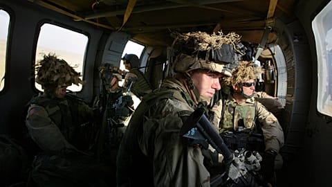 FILE: US Army soldiers sit in Blackhawk helicopter en route for a "presence patrol" near Syrian border in northwestern Iraq, 18 May 2003