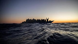 Migrants and refugees wait for assistance on an overcrowded wooden boat in the Mediterranean Sea, 12 February, 2021