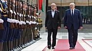 Belarusian President Aliaksandr Lukashenka, right, and Iranian President Masoud Pezeshkian attend a welcome ceremony in Minsk, 20 August, 2025
