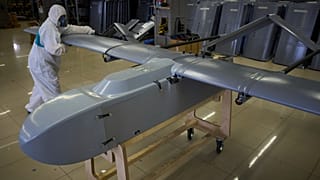 A worker inspects a combat drone at Fire Point's secret factory in Ukraine on Aug. 18, 2025.