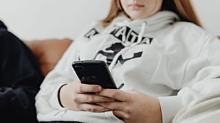 A teenage girl uses her smartphone.