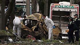 Forensiker inspizieren den Ort einer Bombenexplosion außerhalb eines Luftwaffenstützpunkts in Cali, Kolumbien, am Donnerstag, 21. August 2025. 