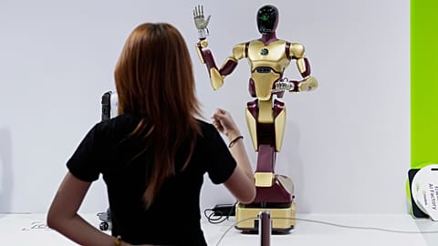 An exhibitor gives command to a robot at Nvidia's booth during the 3rd China International Supply Chain Expo at the China International Exhibition Center, in Beijing, China, F