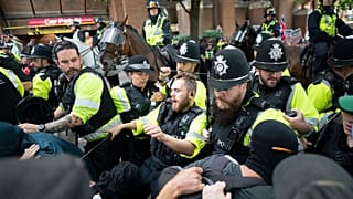 Mounted police officers scuffle with demonstrators during a protest by anti-migrant Abolish Asylum System and counter protesters at Castle Park in Bristol, England, 23/08/2025