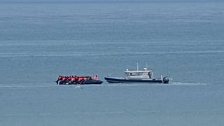 FILE - A boat thought to carry migrants is escorted by a vessel from the French Gendarmerie Nationale in the English Channel off Wimereux, France, Wednesday, Sept. 4, 2024