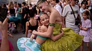 Daria Toma, de 15 años, a la derecha, y Dora, de 10, del Estudio de Ballet de la Ópera Nacional de Rumanía, se abrazan en el exterior del Museo Nacional de Historia de Rumanía durante la Noche de la Danza.