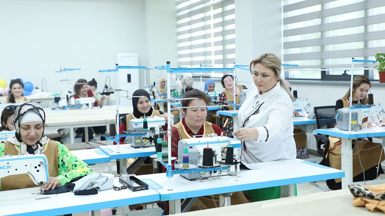 Trainees at the vocational skills centre learning modern sewing techniques with guidance from professional instructors.  