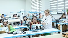 Trainees at the vocational skills centre learning modern sewing techniques with guidance from professional instructors.  