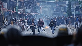 Protesters face riot police during a protest against lavish allowances given to parliament members, in Jakarta, Indonesia, Monday, Aug. 25, 2025.