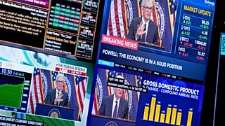 FILE: Televisions display Fed chairman Jerome Powell speaking on the floor at the New York Stock Exchange in New York, 30 July 2025