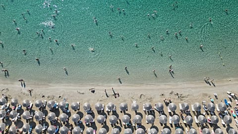 People enjoy the sea in Avlaki beach about 42 kilometres east of Athens