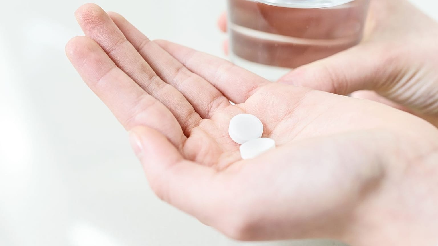 A person takes a pill.