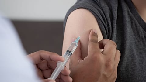 A person receives an injection.