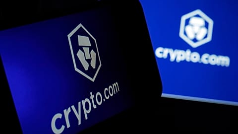 The logo for crypto.com appears on a mobile phone and computer screen, in New York. 31 Jan., 2023.