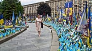 Una mujer observa un monumento improvisado en memoria de los soldados caídos en la guerra entre Rusia y Ucrania en la Plaza de la Independencia de Kiev, Ucrania, el miércoles 9 de julio de 2025.
