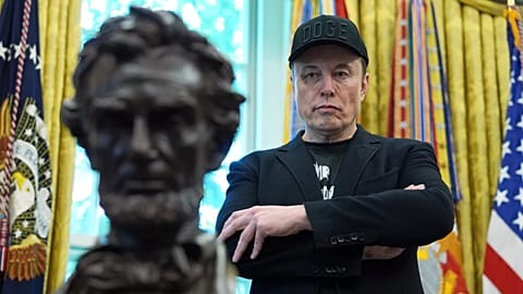 Elon Musk listens as President Donald Trump speaks during a news conference in the Oval Office of the White House, 30 May, 2025