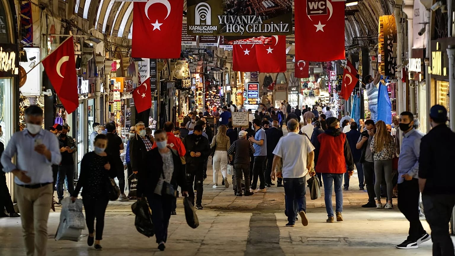 People wearing protective face masks against the spread of coronavirus walk at the iconic 15th century Grand Bazaar in Istanbul, 1 June, 2020