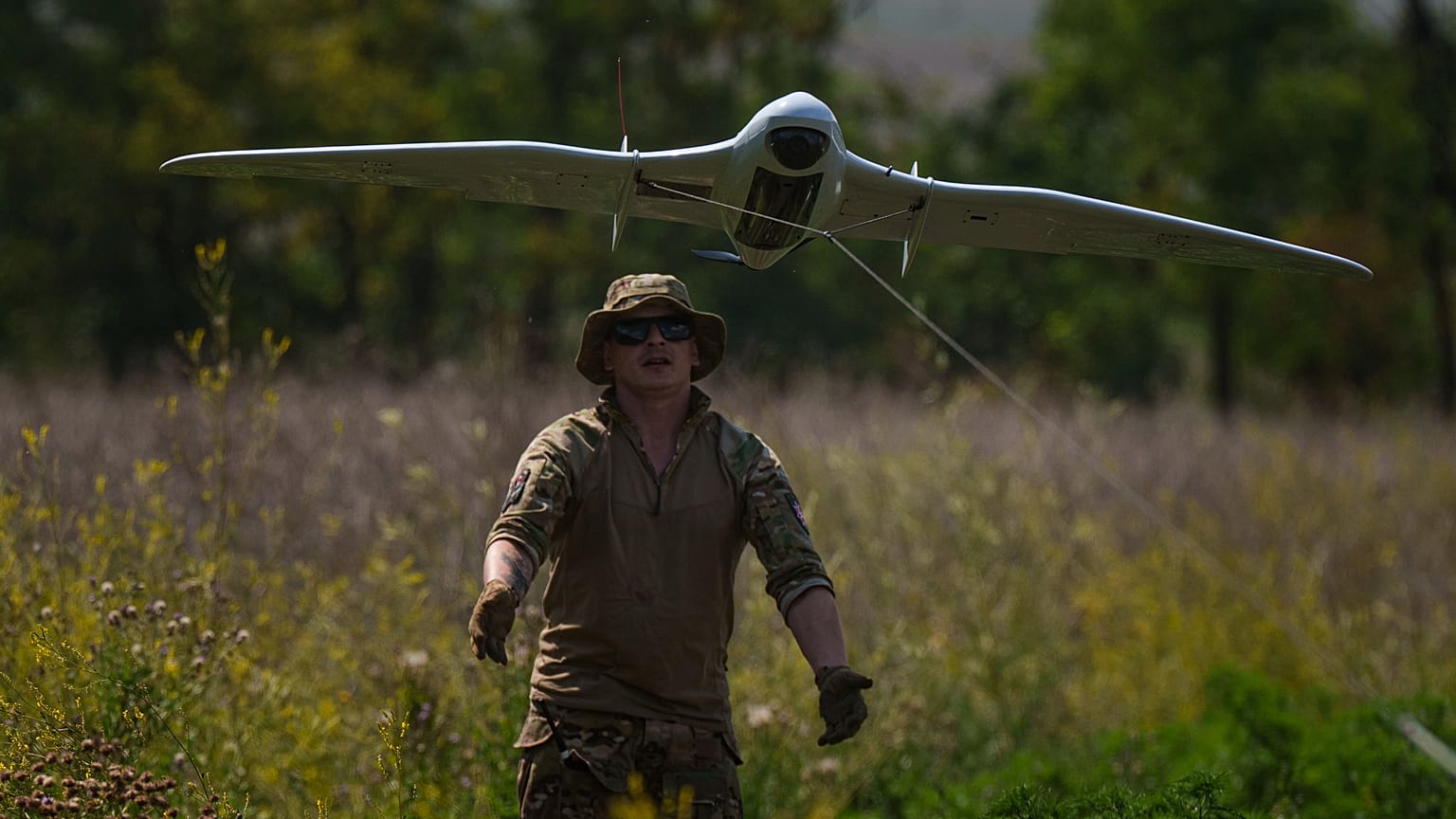 A Ukrainian serviceman of the Ochi reconnaissance unit launches a Furia drone to fly over Russian positions at the frontline in Donetsk region, Ukraine, on Sunday, June 30, 20