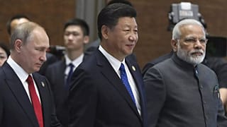 From left, Russian President Vladimir Putin, Chinese President Xi Jinping and Indian Prime Minister Narendra Modi arrive for the Dialogue of Emerging Market and Developing Cou