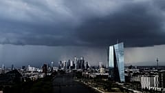Dark clouds roll over the European Central Bank, right, and the buildings of the banking district during a thunder storm in Frankfurt, Germany,