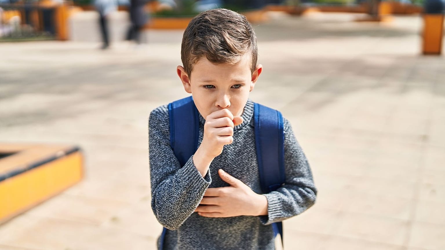 A boy coughs.