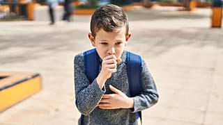 A boy coughs.